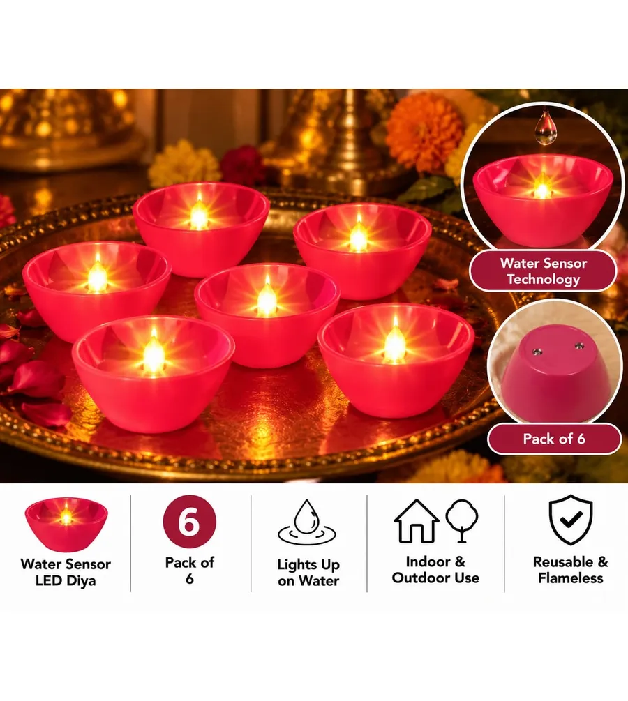 Six red water sensor LED diyas glowing on a brass plate with marigold flowers